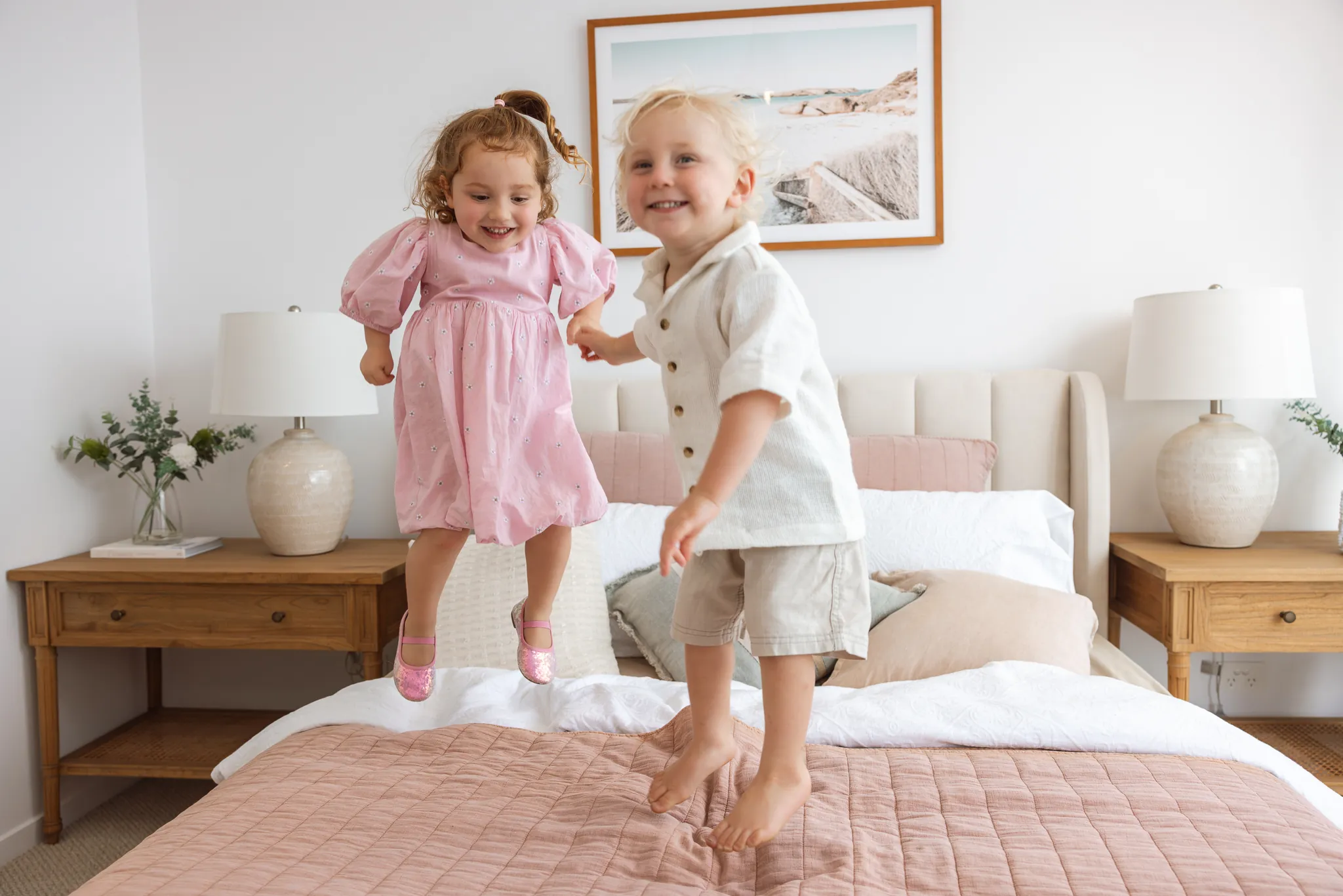 Children playing in a light-filled bedroom