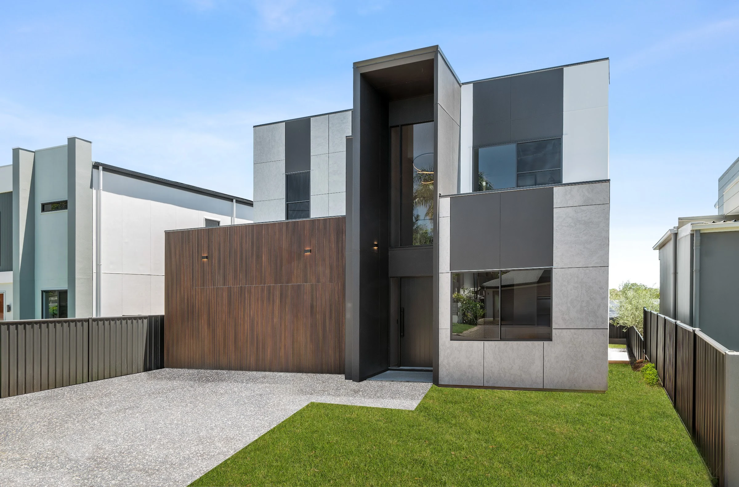 Narrow two storey Arcadia home with a timber screen