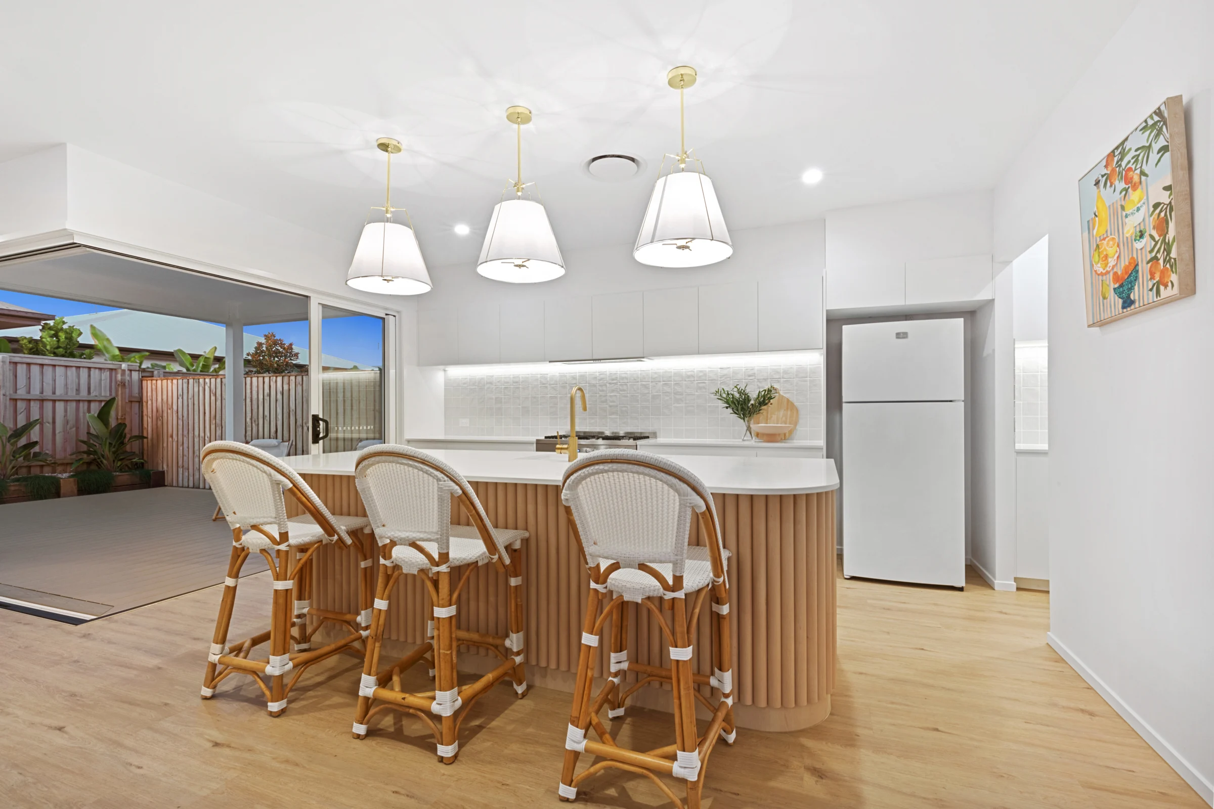 Kitchen island with rattan stools in the Arlo display home, Palmview